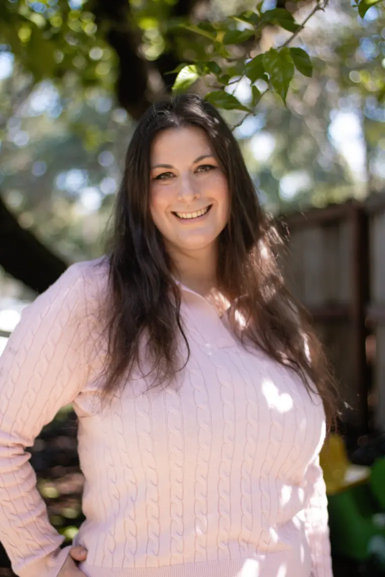 Darden Marx smiling outdoors under the oak trees