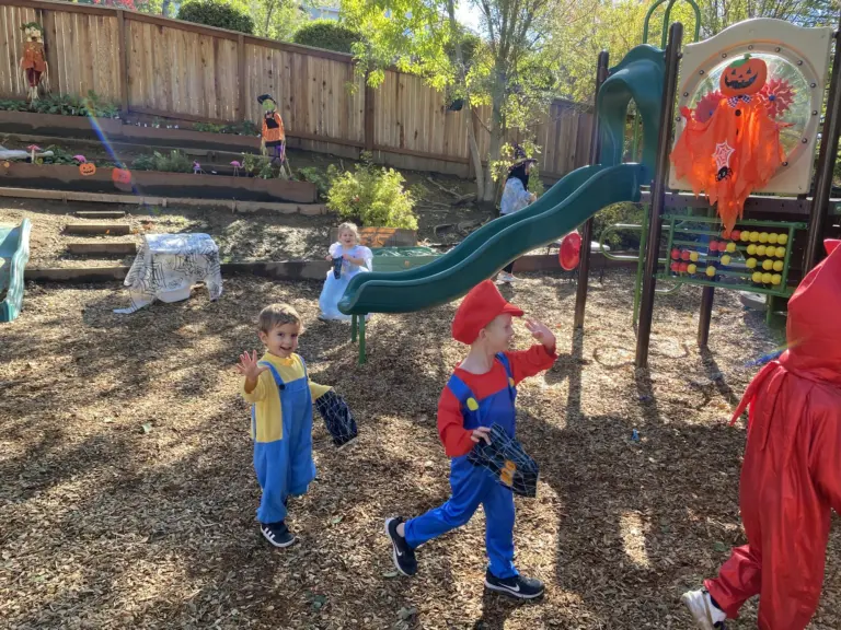 Children dressed as Mario, Luigi and other heroes run around the play yard