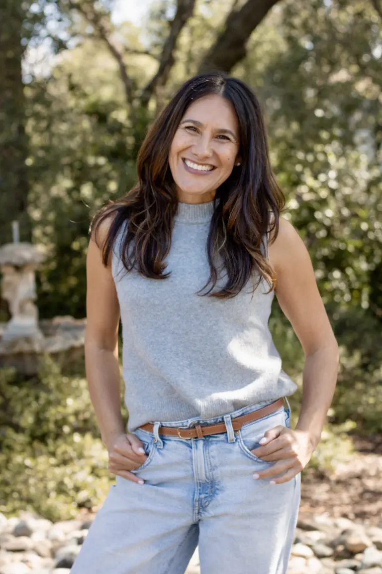 Melissa Mendoza smiling outdoors under the oak trees